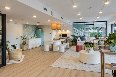 a restaurant with white tables and plants in a room with windows